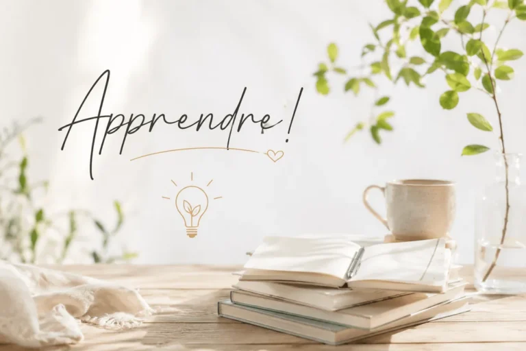 Pile de carnets et tasse de café sur une table de bois clair, avec le mot Apprendre écrit en lettres cursives
